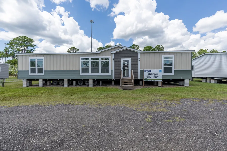Charger manufactured home exterior with two-tone siding and front steps