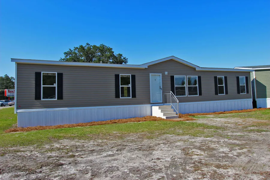Gunner manufactured home exterior in dark gray with white skirting