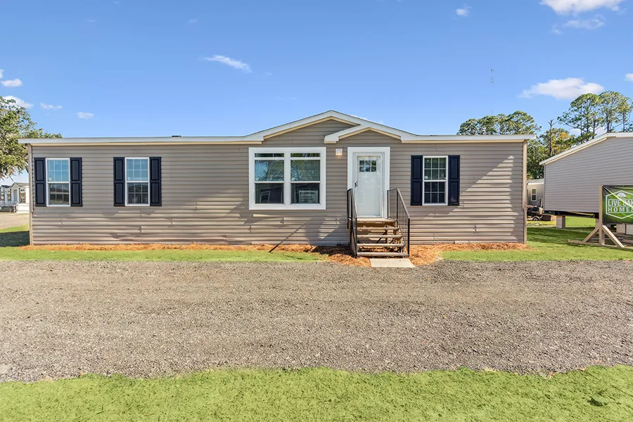 Silverado manufactured home exterior in tan with front steps