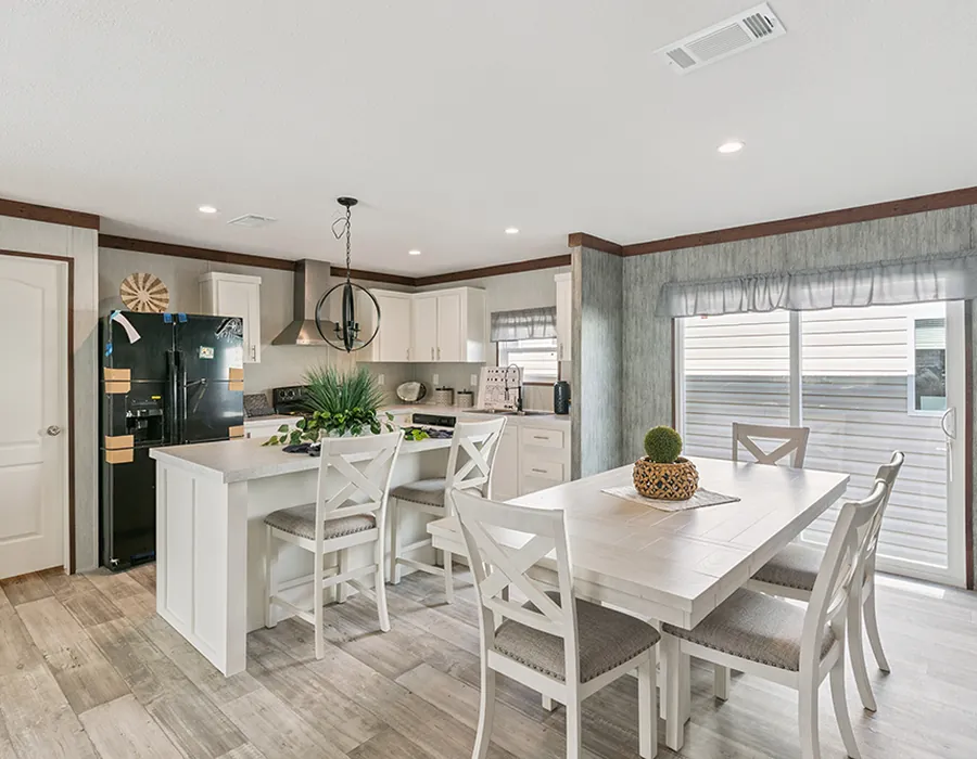 Bright dining area with a white table next to the kitchen